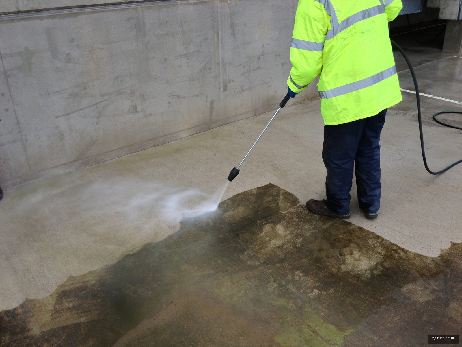 Industrial pressure washing of a factory exterior